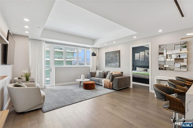 800 Ave At Port Imperial Blvd Unit 517, Weehawken, NJ 07086 - living room featuring wood finished floors, a raised ceiling, baseboards, and recessed lighting