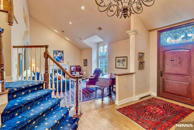 717 Ashmont Rd, Franklin Lakes, NJ 07417 - entrance foyer featuring a chandelier, high vaulted ceiling, wood finished floors, recessed lighting, and ornate columns