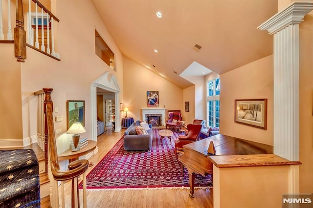 717 Ashmont Rd, Franklin Lakes, NJ 07417 - living room featuring wood finished floors, ornate columns, high vaulted ceiling, recessed lighting, and a fireplace