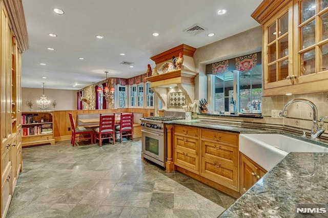717 Ashmont Rd, Franklin Lakes, NJ 07417 - kitchen featuring stainless steel range, a sink, dark stone counters, recessed lighting, and a chandelier