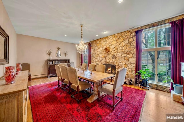 717 Ashmont Rd, Franklin Lakes, NJ 07417 - dining space with healthy amount of natural light, a chandelier, wood finished floors, baseboard heating, and recessed lighting