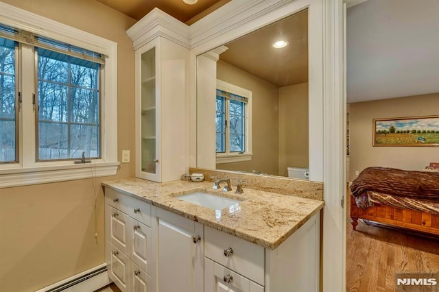 717 Ashmont Rd, Franklin Lakes, NJ 07417 - bathroom with vanity, baseboard heating, wood finished floors, recessed lighting, and ensuite bath