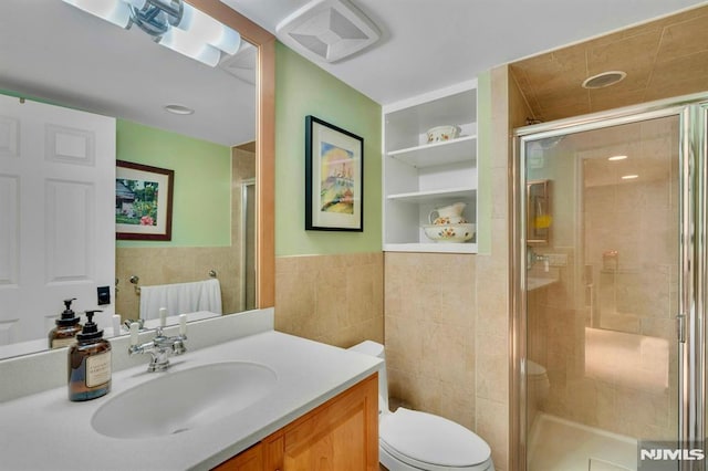 717 Ashmont Rd, Franklin Lakes, NJ 07417 - full bathroom featuring tile walls, vanity, toilet, a stall shower, and a wainscoted wall