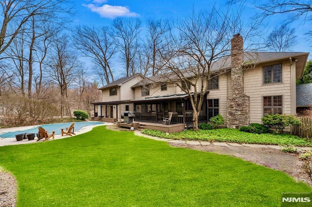 717 Ashmont Rd, Franklin Lakes, NJ 07417 - back of house featuring a chimney, a covered pool, roof with shingles, and a patio area