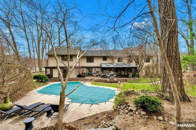717 Ashmont Rd, Franklin Lakes, NJ 07417 - view of pool featuring a wooden deck, a covered pool, and a patio