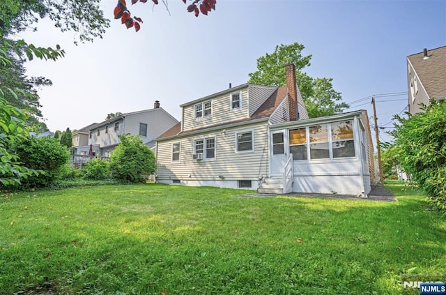 11 Newman Ave, Nutley, NJ 07110 - back of property featuring entry steps, a lawn, a chimney, and a sunroom