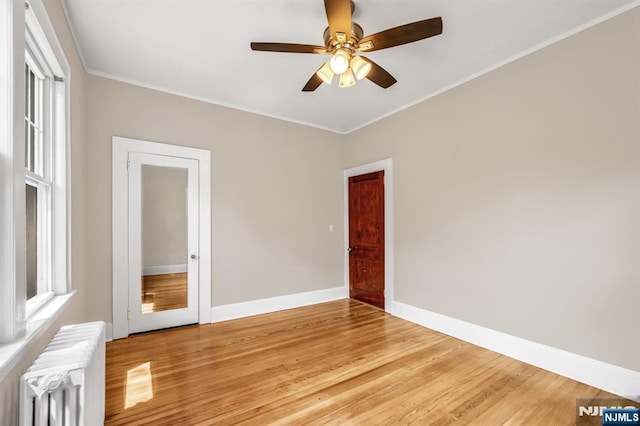 67 Woodland Rd, Bloomfield, NJ 07003 - spare room featuring radiator heating unit, ceiling fan, light wood finished floors, ornamental molding, and baseboards