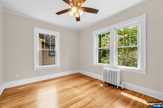 67 Woodland Rd, Bloomfield, NJ 07003 - unfurnished room featuring radiator heating unit, ornamental molding, light wood finished floors, baseboards, and a ceiling fan