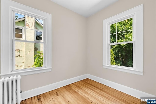 67 Woodland Rd, Bloomfield, NJ 07003 - empty room featuring radiator, plenty of natural light, baseboards, and wood finished floors