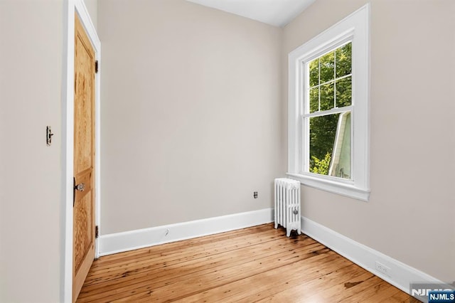 67 Woodland Rd, Bloomfield, NJ 07003 - empty room featuring radiator heating unit, light wood finished floors, and baseboards