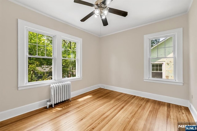 67 Woodland Rd, Bloomfield, NJ 07003 - spare room featuring radiator heating unit, baseboards, light wood finished floors, ornamental molding, and a ceiling fan
