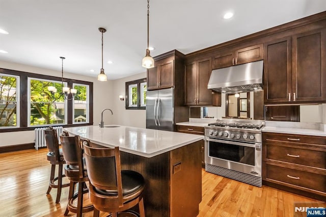 67 Woodland Rd, Bloomfield, NJ 07003 - kitchen with appliances with stainless steel finishes, under cabinet range hood, a sink, light wood-style flooring, and recessed lighting