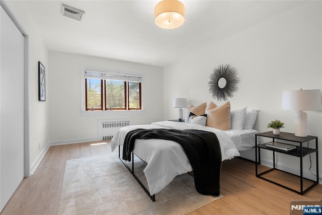530 Broad Ave Unit 2, Englewood, NJ 07631 - bedroom with radiator heating unit, light wood finished floors, and baseboards