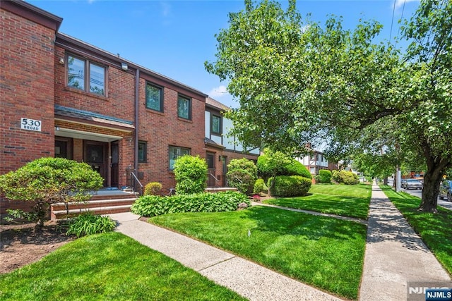 530 Broad Ave Unit 2, Englewood, NJ 07631 - view of front of house with brick siding and a front lawn