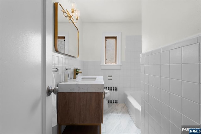 530 Broad Ave Unit 2, Englewood, NJ 07631 - bathroom featuring radiator heating unit, tile walls, vanity, toilet, and a tub