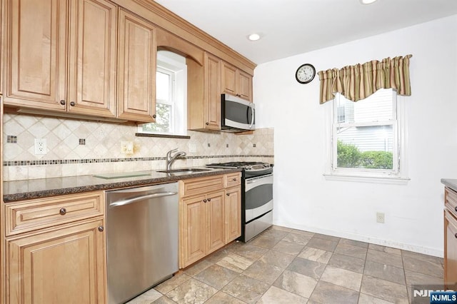 408 Terhune Ave, Paramus, NJ 07652 - kitchen with stainless steel appliances, a sink, dark stone countertops, backsplash, and baseboards