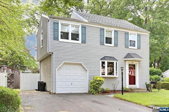408 Terhune Ave, Paramus, NJ 07652 - view of front of property with an attached garage, driveway, a shed, and roof with shingles