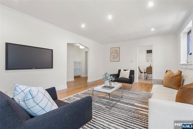 530 Broad Ave Unit 17, Englewood, NJ 07631 - living room featuring arched walkways, light wood-style floors, recessed lighting, ornamental molding, and baseboards