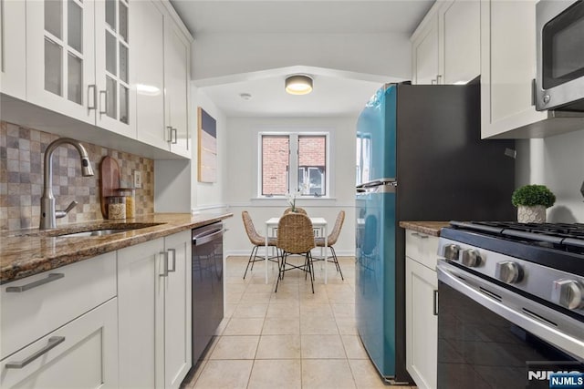 530 Broad Ave Unit 17, Englewood, NJ 07631 - kitchen featuring appliances with stainless steel finishes, a sink, white cabinetry, and stone counters
