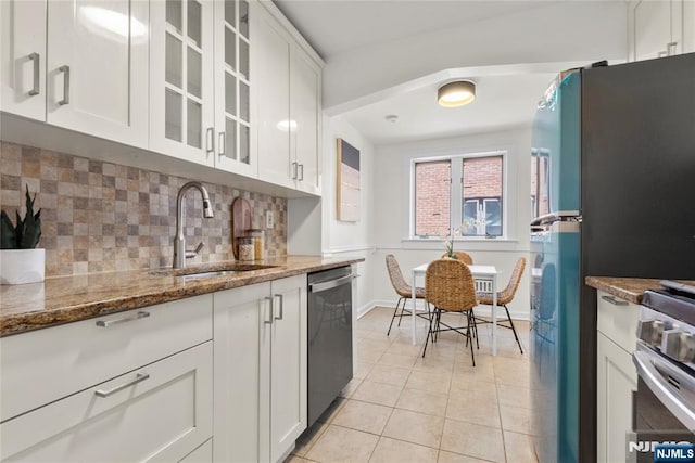 530 Broad Ave Unit 17, Englewood, NJ 07631 - kitchen with a sink, stainless steel appliances, light tile patterned floors, stone countertops, and white cabinetry