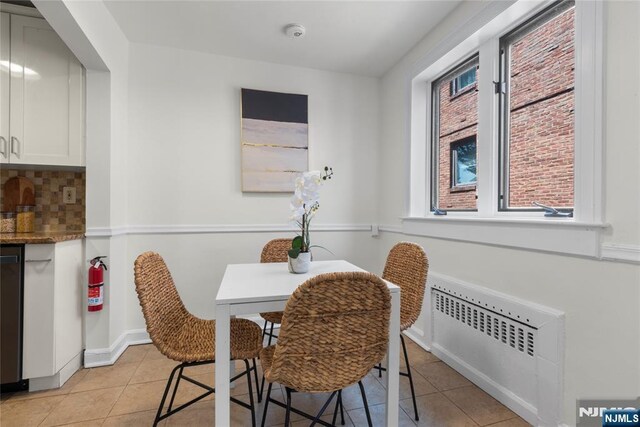 530 Broad Ave Unit 17, Englewood, NJ 07631 - dining room with radiator heating unit and light tile patterned floors