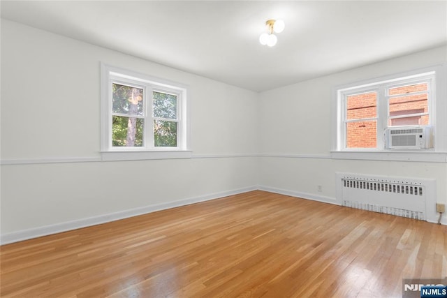 530 Broad Ave Unit 17, Englewood, NJ 07631 - unfurnished room featuring radiator heating unit, light wood finished floors, cooling unit, and baseboards