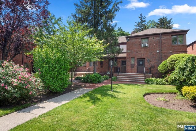 530 Broad Ave Unit 17, Englewood, NJ 07631 - rear view of property with a yard and brick siding
