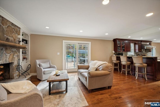 14 Old Chimney Rd, Randolph Township, NJ 07869 - living room featuring wood finished floors, recessed lighting, crown molding, a stone fireplace, and built in shelves