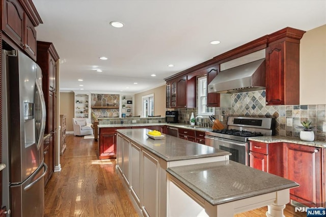 14 Old Chimney Rd, Randolph Township, NJ 07869 - kitchen with wall chimney range hood, stainless steel appliances, a kitchen island, a peninsula, and dark brown cabinets