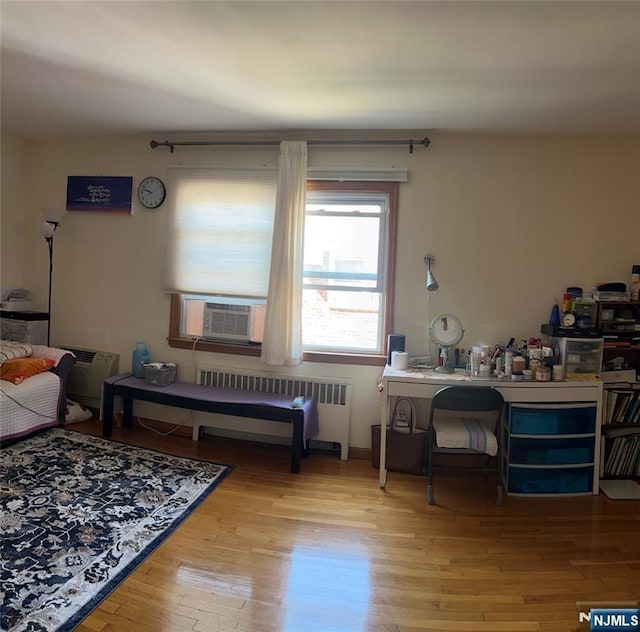 715 Broad Ave Unit 5A, Ridgefield, NJ 07657 - living room with cooling unit, radiator heating unit, and wood finished floors