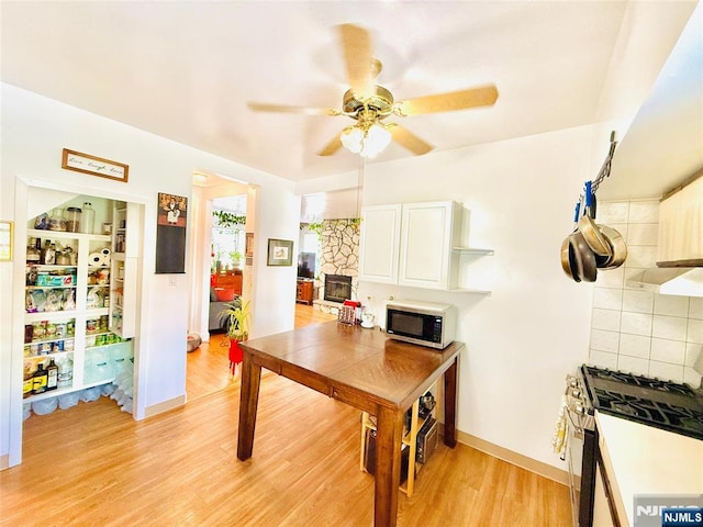 22 Church St, Nutley, NJ 07110 - kitchen with stainless steel range with gas cooktop, white cabinetry, a ceiling fan, light wood finished floors, and open shelves