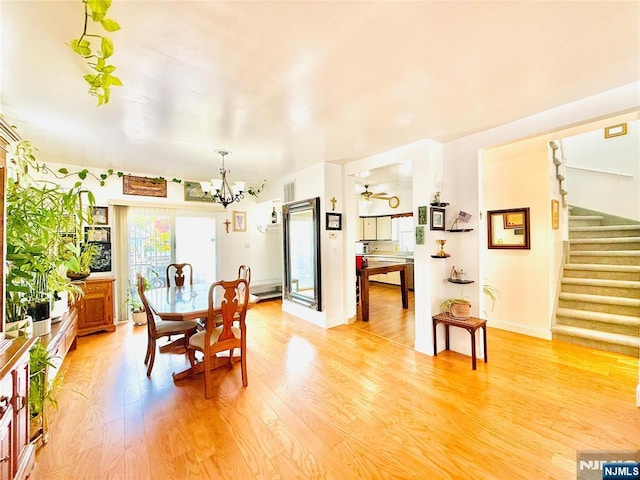 22 Church St, Nutley, NJ 07110 - dining space with stairway, light wood-type flooring, and a chandelier