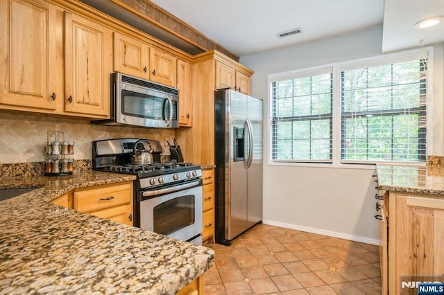 22 Foxboro Ln Unit H, West Milford, NJ 07480 - kitchen featuring appliances with stainless steel finishes, plenty of natural light, and decorative backsplash