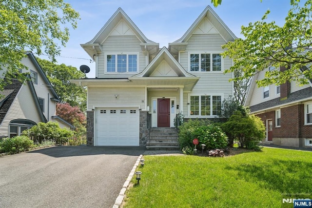 19 Grandview Ave, Glen Rock, NJ 07452 - view of front of house with a garage, a front yard, asphalt driveway, and stone siding