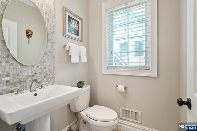 19 Grandview Ave, Glen Rock, NJ 07452 - half bathroom with backsplash, toilet, healthy amount of natural light, and a sink