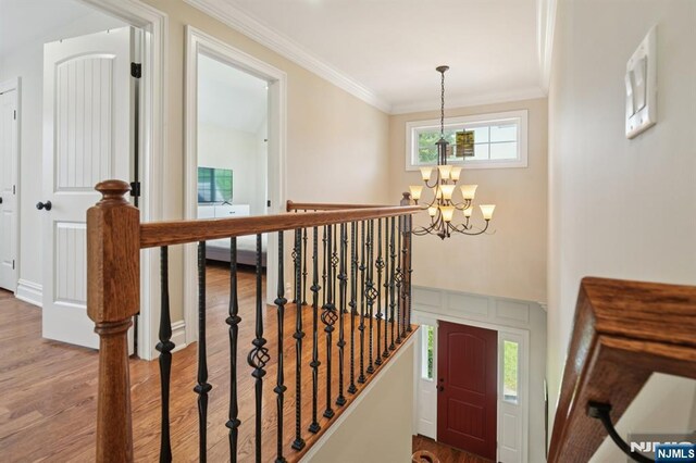 19 Grandview Ave, Glen Rock, NJ 07452 - stairs featuring a chandelier, crown molding, and wood finished floors