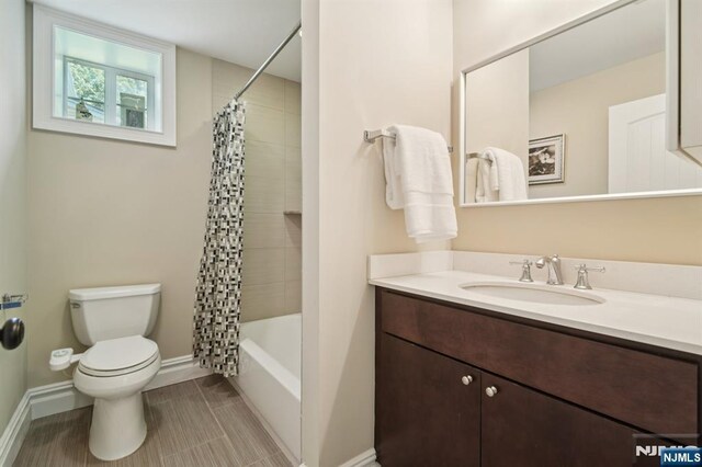 19 Grandview Ave, Glen Rock, NJ 07452 - full bathroom with vanity, toilet, baseboards, tile patterned floors, and shower / tub combo