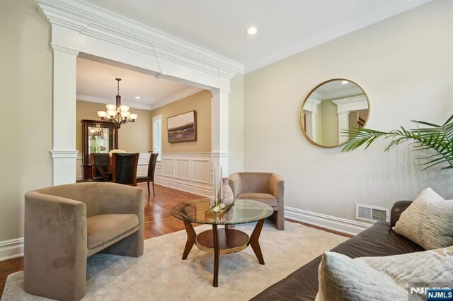 19 Grandview Ave, Glen Rock, NJ 07452 - living area featuring decorative columns, a chandelier, crown molding, recessed lighting, and wainscoting