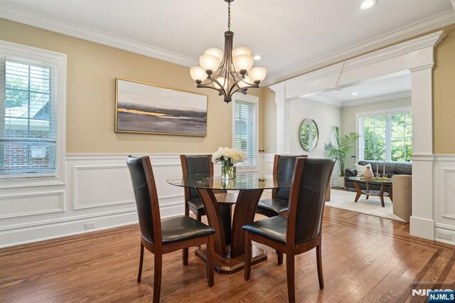 19 Grandview Ave, Glen Rock, NJ 07452 - dining area with a chandelier, wood finished floors, healthy amount of natural light, ornamental molding, and a wainscoted wall