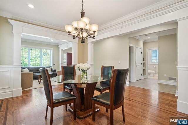 19 Grandview Ave, Glen Rock, NJ 07452 - dining room with decorative columns, a chandelier, ornamental molding, wood finished floors, and recessed lighting
