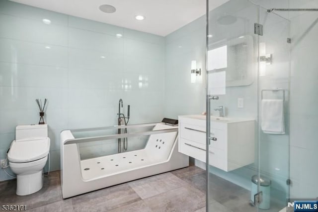 3-11 Lyncrest Ave, Fair Lawn, NJ 07410 - full bath with toilet, vanity, a freestanding tub, a stall shower, and tile walls