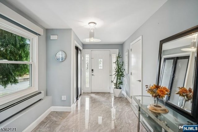 3-11 Lyncrest Ave, Fair Lawn, NJ 07410 - entrance foyer with a baseboard heating unit, marble tiled floors, and baseboards