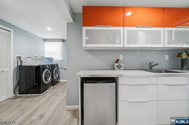 3-11 Lyncrest Ave, Fair Lawn, NJ 07410 - bar featuring stainless steel refrigerator, independent washer and dryer, a sink, light wood-style flooring, and baseboards