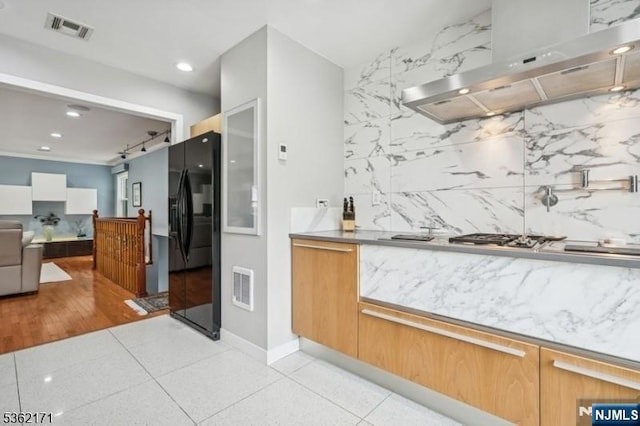 3-11 Lyncrest Ave, Fair Lawn, NJ 07410 - kitchen featuring black fridge with ice dispenser, exhaust hood, open floor plan, recessed lighting, and baseboards