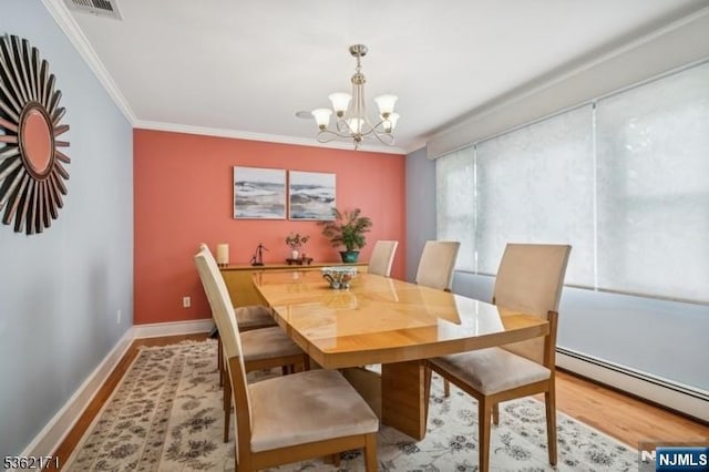 3-11 Lyncrest Ave, Fair Lawn, NJ 07410 - dining area with ornamental molding, wood finished floors, a chandelier, a baseboard radiator, and baseboards