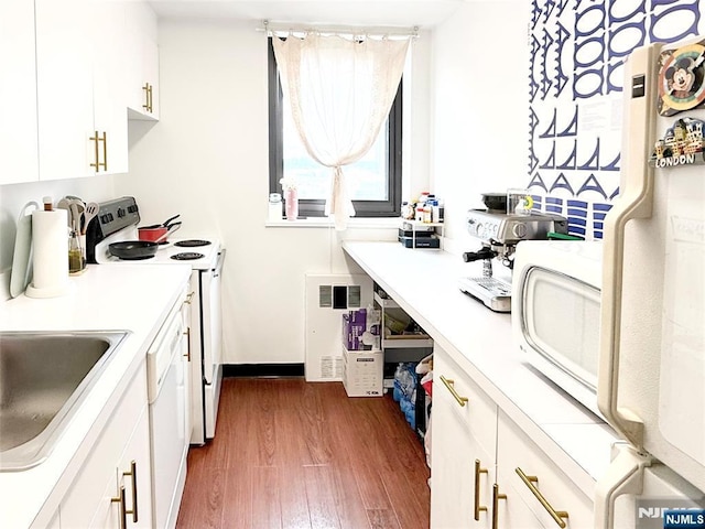 90 Prospect Ave Unit 10G, Hackensack, NJ 07601 - kitchen featuring white appliances, dark wood finished floors, white cabinetry, light countertops, and a sink