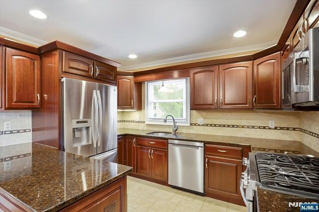 5 Edgewood Ct, Ringwood, NJ 07456 - kitchen featuring stainless steel appliances, dark stone countertops, decorative backsplash, crown molding, and a peninsula