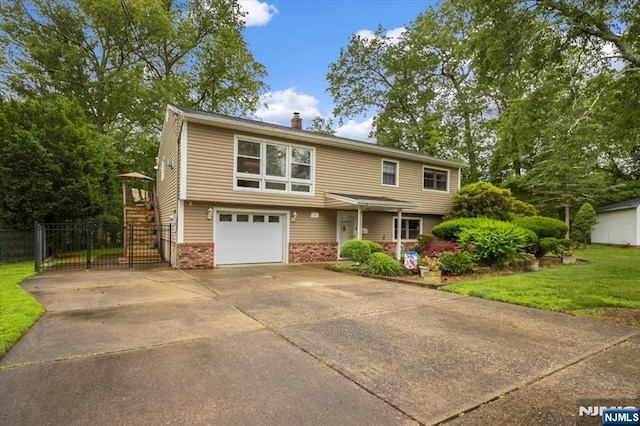 5 Edgewood Ct, Ringwood, NJ 07456 - view of front of house featuring brick siding, concrete driveway, a chimney, a garage, and stairway