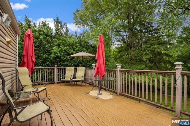 5 Edgewood Ct, Ringwood, NJ 07456 - wooden deck with view of scattered trees