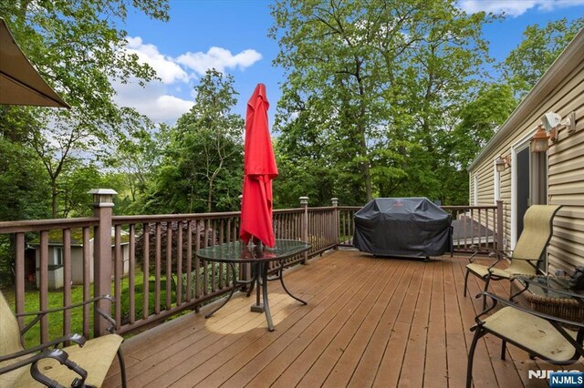 5 Edgewood Ct, Ringwood, NJ 07456 - wooden deck with area for grilling and view of wooded area